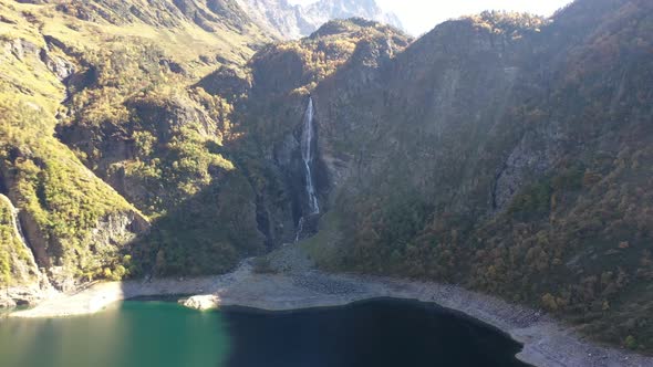 Lac d'Oô waterfall at the artificial lake in the French Pyrenees created by the runoff of Lake d'Esp