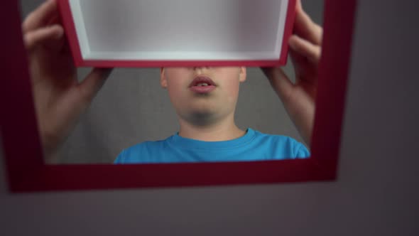 Excited boy Opens birthday present or Christmas gift - unique camera perspective from inside the box