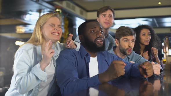 Friends Watching Sports Together in Bar, Upset About Losing Game, Disappointed