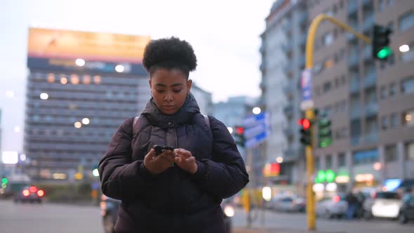 Slow motion young black woman outdoor using smart phone