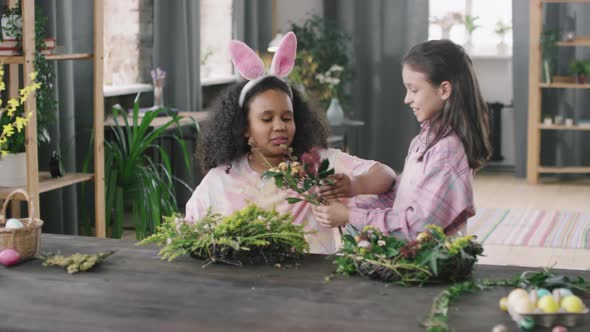 Cute Girls Making Flower Arrangement for Easter