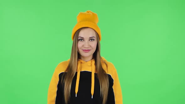 Portrait of Modern Girl in Yellow Hat Is Smiling. Green Screen