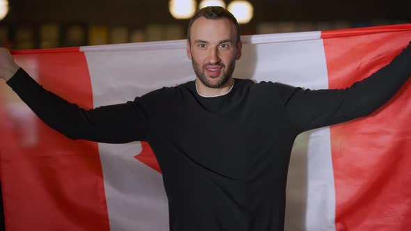 Front View Young Handsome Caucasian Man with Canadian Flag Talking Smiling Looking at Camera