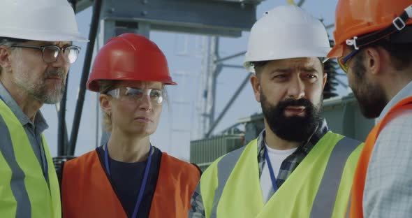 Foreman Speaking with Colleagues on Power Station