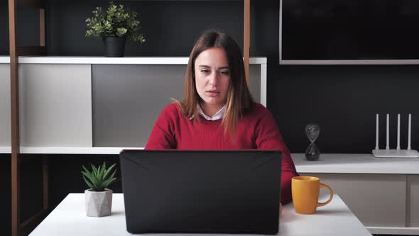 Stressed Young Businesswoman with Laptop Having Headache