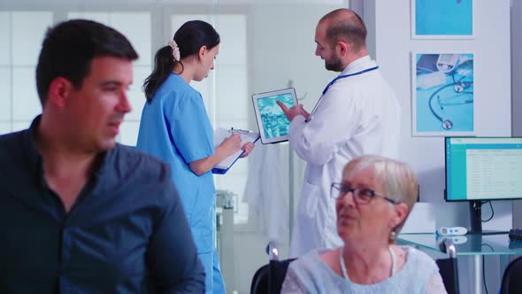 Doctor Checking Radiography on Nurse Digital Tablet