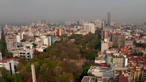 Aerial View From Drone Flying Over Town Park Surrounded By Urban Housing