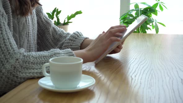 Close Up of Hands Woman Using Her Tablet Pc in Cafe