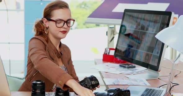 Female executive repairing a digital camera 4k