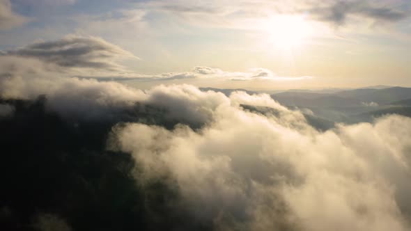 Fly up over Organic Clouds, Aerial Landscape above Mountain in Spring Season