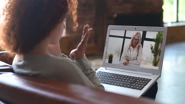 Young Woman Having Online Meeting with Female Healthcare Person