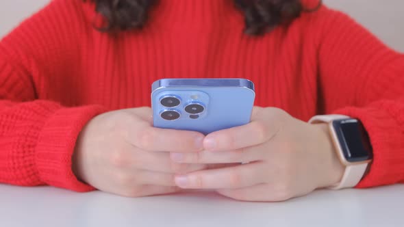 Woman texting online on social media application on modern blue smartphone in 4k video