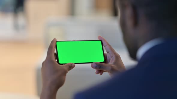 African Man Watching Smartphone with Chroma Screen 