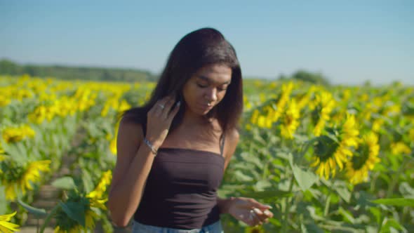 Pretty Black Woman Relaxing in Sunflower Fiield