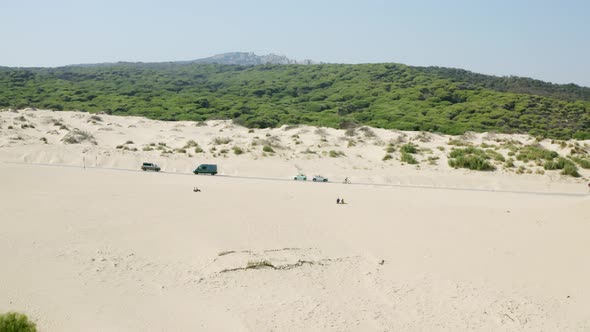 Car driving desert road at dune de valdevaqueros