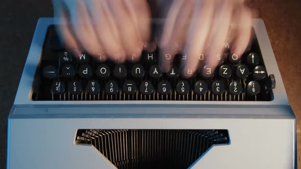 A man typing on a typewriter