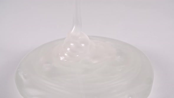 Pouring the White Cosmetic Gel Cream With Molecule Bubbles