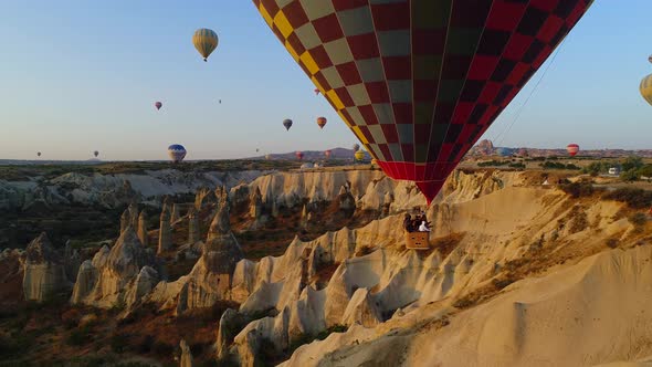 Tourist And Balloons In Cappadocia