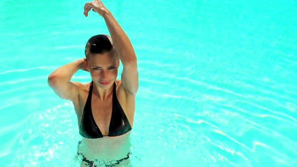 Slow Motion Shot of a Blonde Model Pouring Water Over Her Head