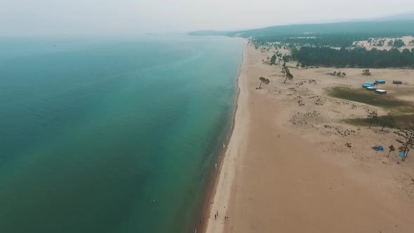 Aerial View of Sand Beach and Crystal Clean Water Crashing Sea Waves