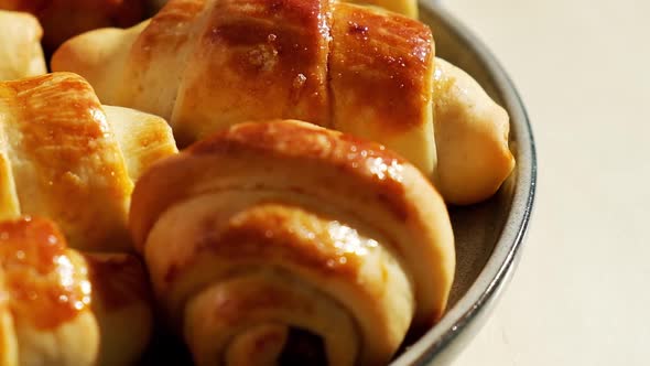 Homemade Delicious Croissants on a Dessert Gray Plate on Kitchen Towel Rotating