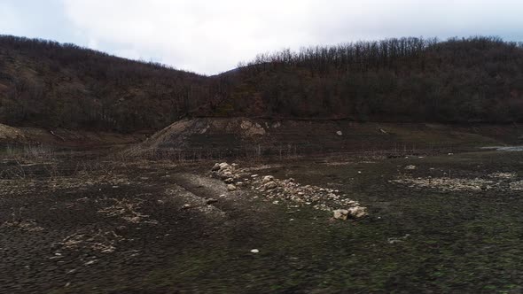 Aerial view of a withered field and hills