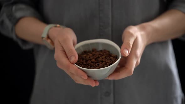 Anonymous woman with coffee beans