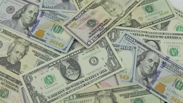 Dollar Bills Fall on the Table with American Dollars of Different Denominations