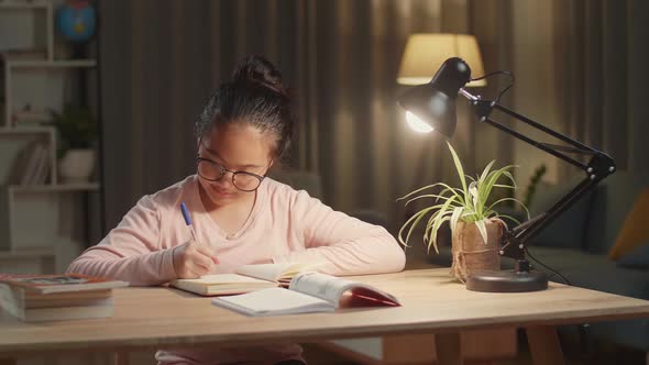 Asian Girl Is Studying At Home, Asia Child Doing Homework At Night