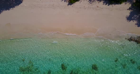 Luxury fly over abstract shot of a sunshine white sandy paradise beach and blue water background in 