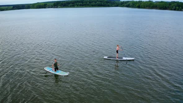 Drone view of couple on sup paddle boards