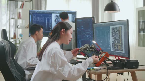 Asian Engineer And Team Of Multi Scientists Work On Computers, Design Industrial Pcb