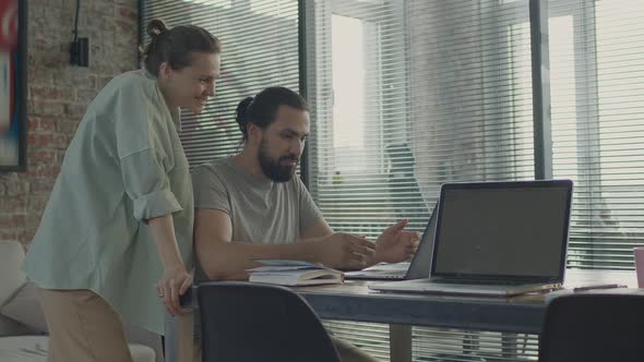 The Young Employees a Man and a Woman Have Fun Talking to Each Other and Laugh