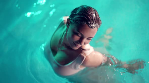 Pretty Woman in Pool Water with Smoke Background