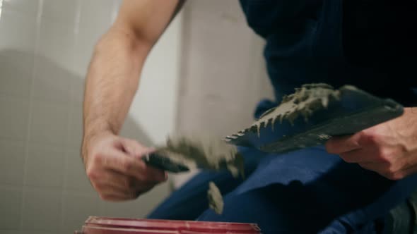 Builder Laying Tiles Using Cement and Spatula Man Installing Ceramic Slabs on Floor and Walls