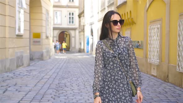 Woman Walking in City. Young Attractive Tourist Outdoors in Italian City