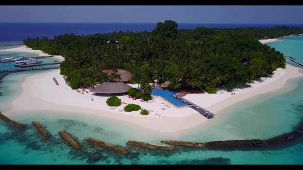 Aerial drone shot scenery of tropical island beach holiday by clear sea and bright sandy background 