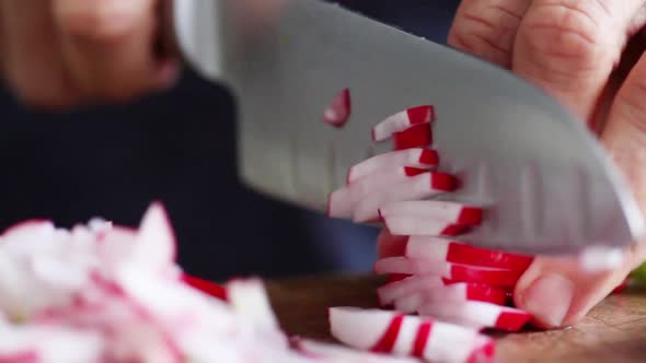 Woman cutting radishes