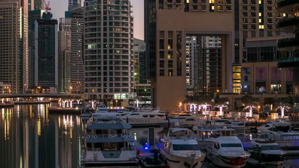 View of Dubai Marina Towers and Canal in Dubai Night to Day Timelapse