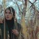 A Young Brunette Among the Reeds Plucks a Straw and Puts It in Her Mouth - VideoHive Item for Sale