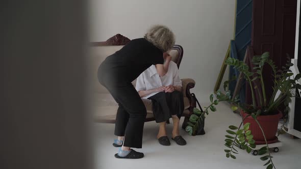 Mature Daughter Corrects Her Old Mother's Hairstyle in Studio