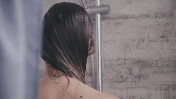 Back Look of Woman Goes Out Under Shower