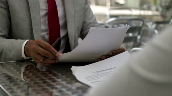 Front View of Male Hands Signing Documents