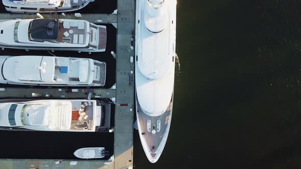 A bird's eye video flying over a mega yacht from bow to stern.