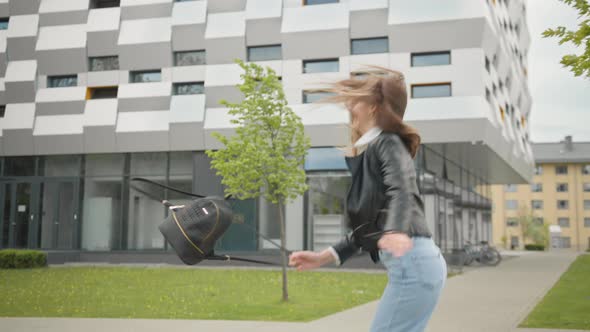 Stylishly Dressed Woman Having Fun Outdoor in Jeans Outfit