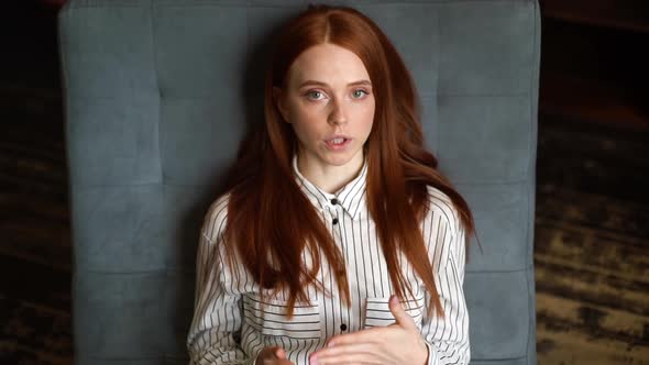 Top View of Red-haired Young Woman Lying on Armchair and Telling About Problems To Psychotherapist.