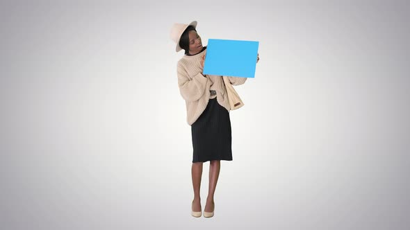 African American Woman Holding a Blank Placard on Gradient Background