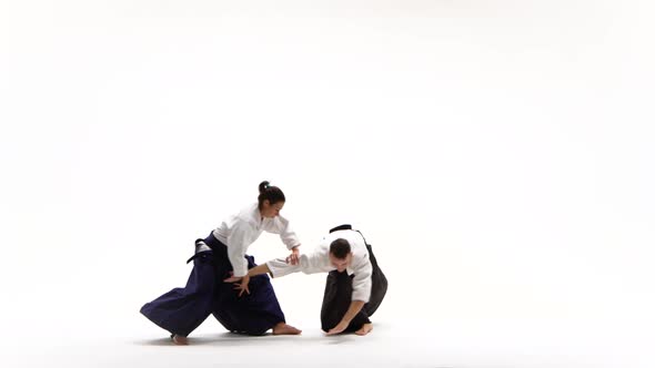 Maiden, Fellow Performing Aikido Techniques, Isolated on White. Close Up.