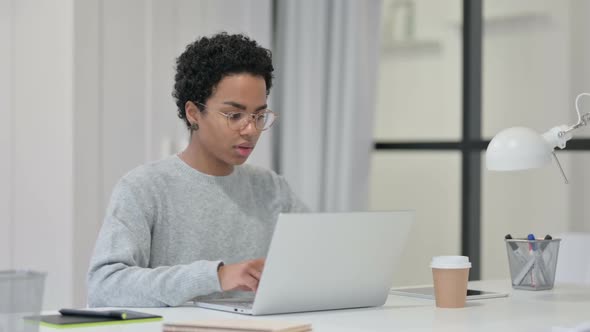 African Woman Working on Laptop in Office