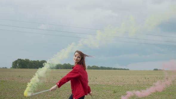 Woman with Colored Smoke Bomb Relaxing in Nature